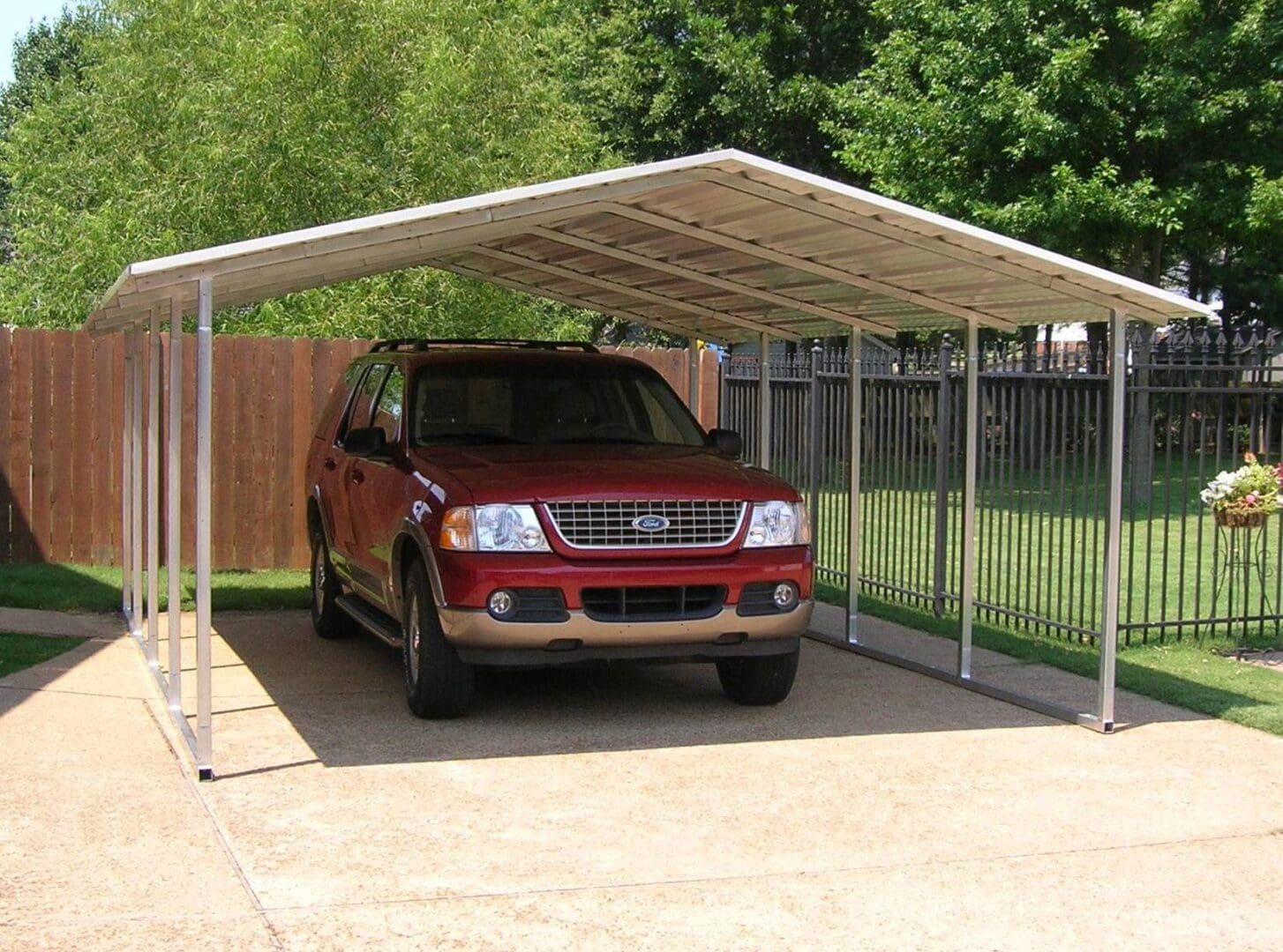 A red truck parked in the driveway of a house.