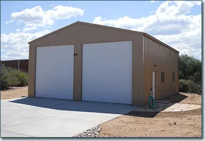 A large building with two doors and a driveway.